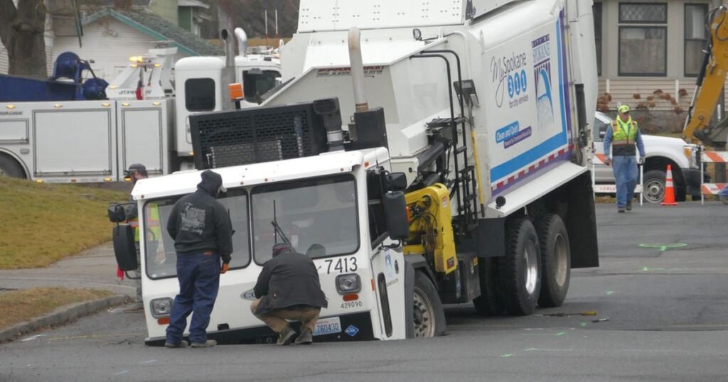Spokane recycling truck falls through hole in street - The Spokesman Review