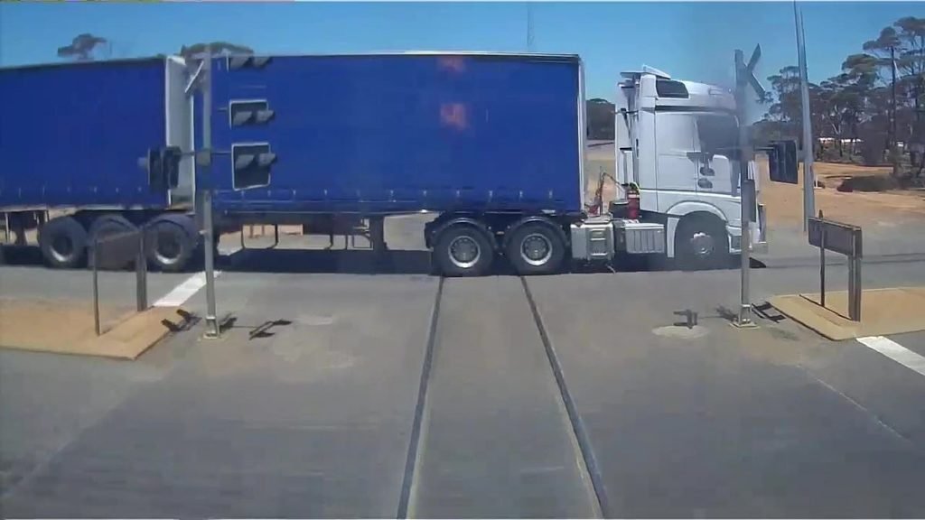 Watch the terrifying moment a freight train almost collides with a truck in WA's Goldfields Esperance region - Daily Mail