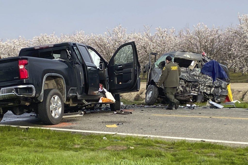 The site of a head-on crash involving a van and a pickup truck where eight people were killed is checked in Madera County, Calif., Friday, Feb. 23, 2024. California Highway Patrol Officer Javier Ruvalcaba told the Fresno Bee that seven of those killed were farmworkers traveling in a van. The other person killed was in a pickup truck, he said. (Anthony Galaviz/The Fresno Bee via AP)