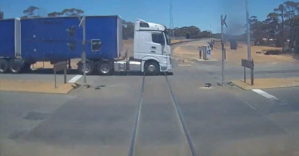 Watch the heart-stopping moment a freight train barely misses truck - 9News