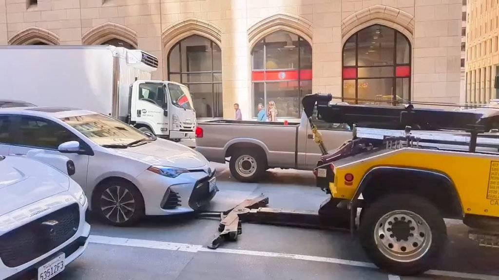 San Francisco tow truck tries to drag away car with driver still inside: Beleaguered company owners previously - Daily Mail