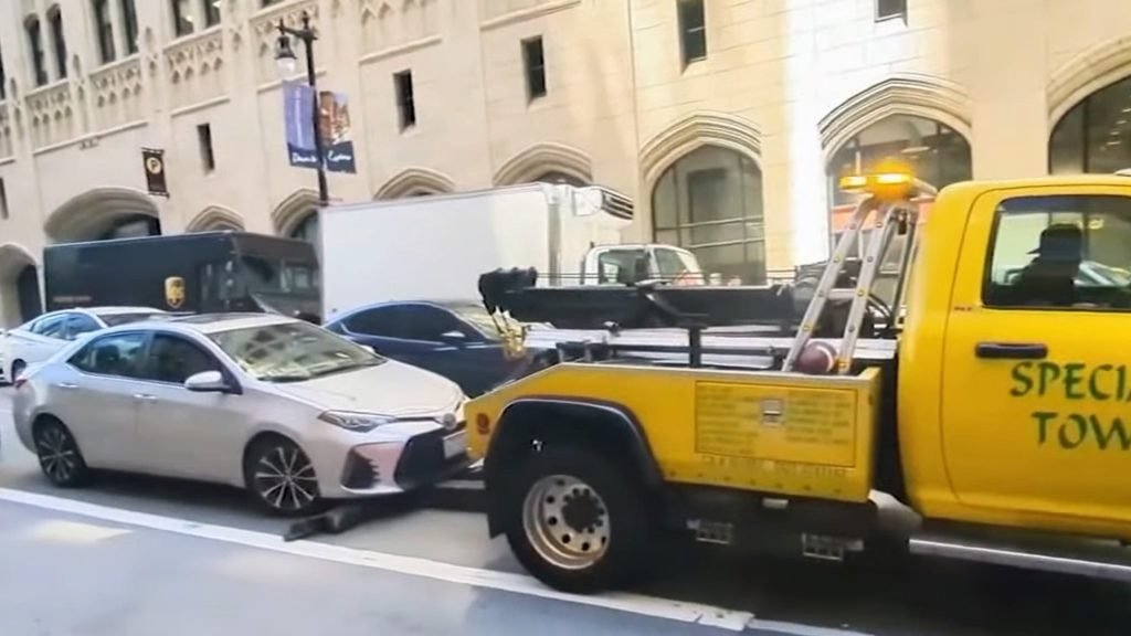 A Shady Tow Truck Tried to Haul Away a Moving Car, Then Chased After It - The Drive