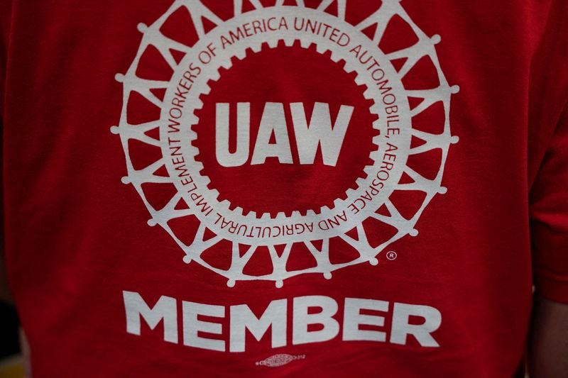 FILE PHOTO: A person wearing a T-shirt that has "UAW member" written on it is pictured as the result of a vote comes in favour of the hourly factory workers at Volkswagen's assembly plant to join the United Auto Workers (UAW) union, during a watch party in Chattanooga, Tennessee, U.S., April 19, 2024.  REUTERS/Seth Herald/File Photo